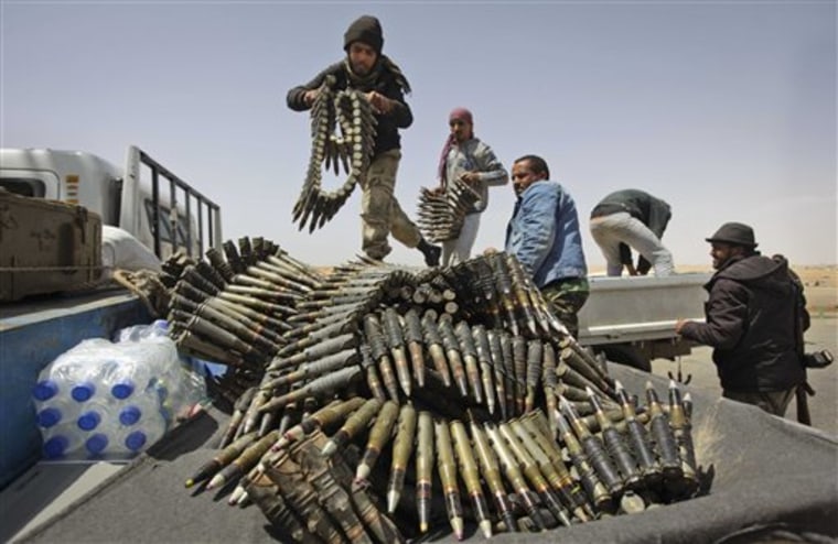 Libyan rebel fighters load a truck with ammunition on the outskirts of Ajdabiya, Libya, Saturday, April 16, 2011. 